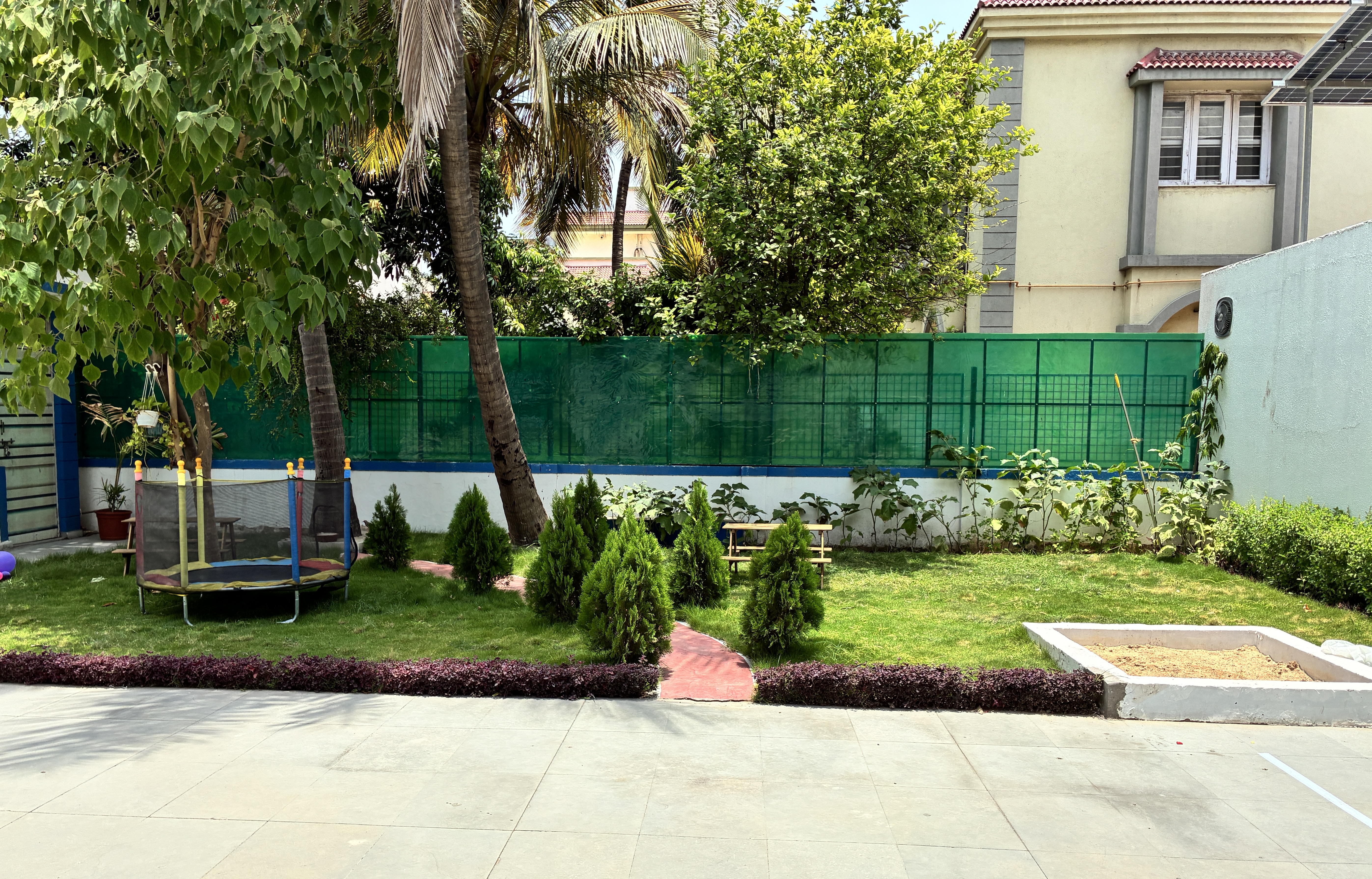 Green grass garden sandbox and trampoline combo