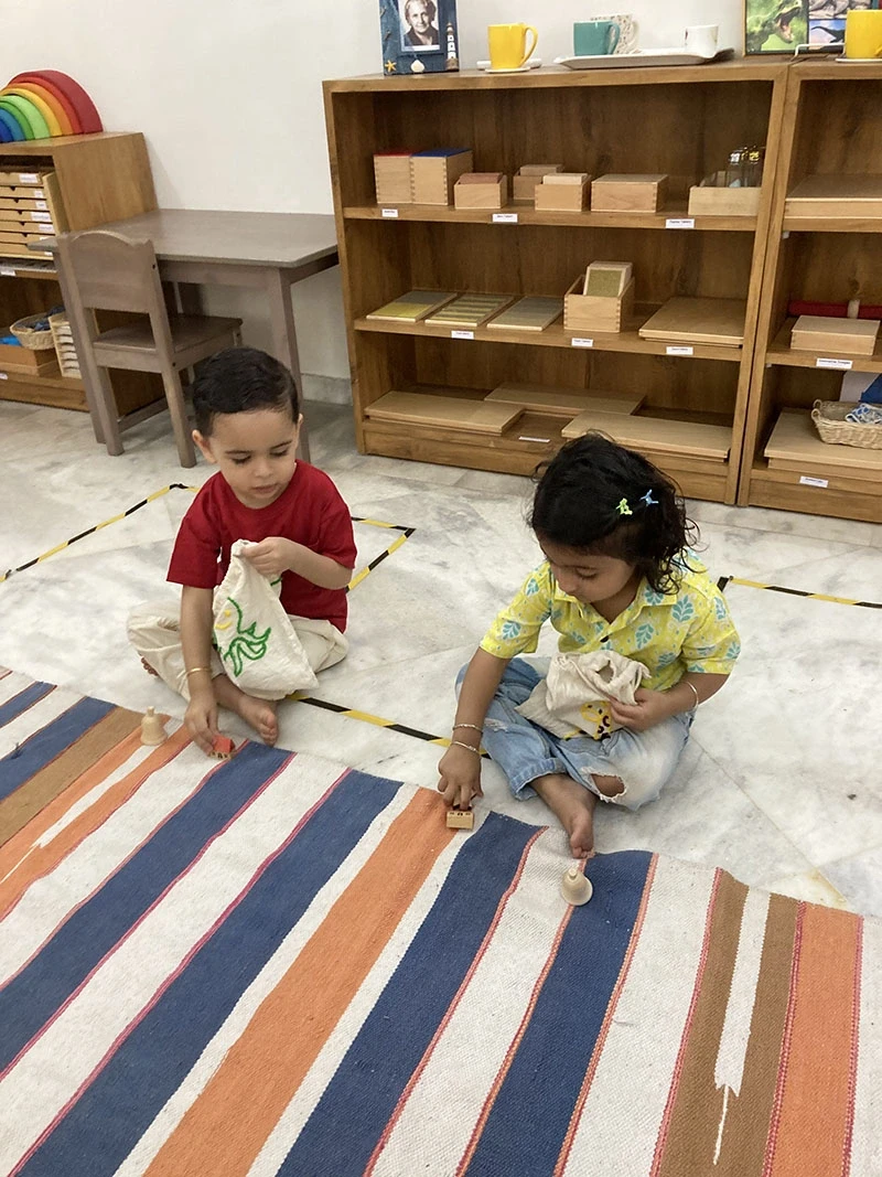 Child working with Sandpaper Letters and phonics outlines